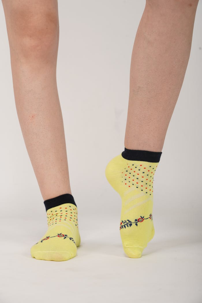 Offerings Stylish yellow socks with black trim, perfect for bold fashion statements.